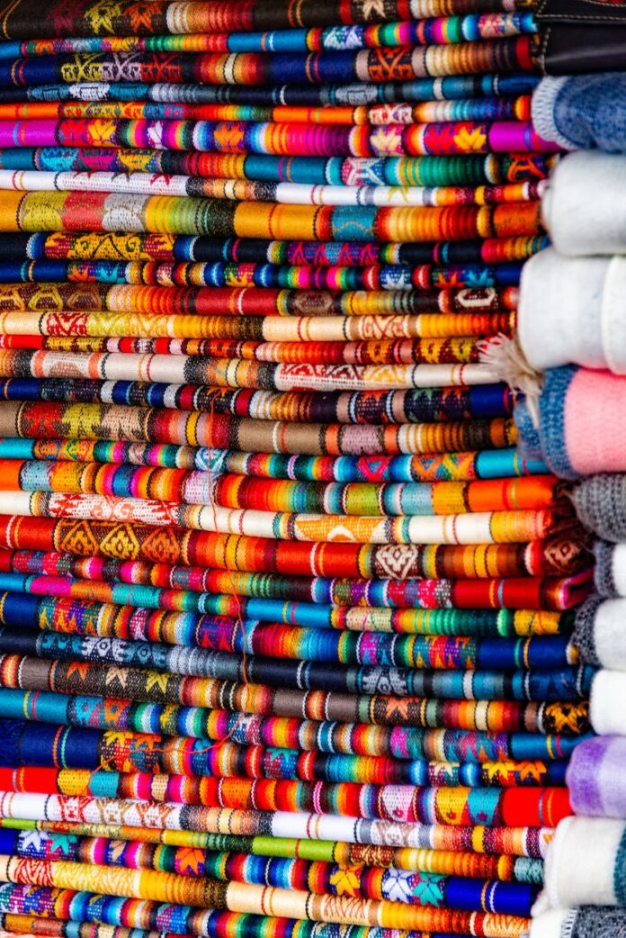 pexels-photo-18506888 stack of multicolored ornamented traditional textile fabric
