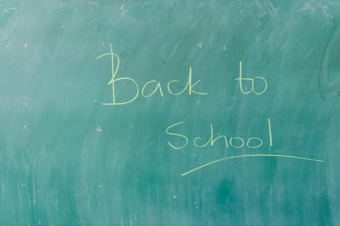 back to school message on school blackboard