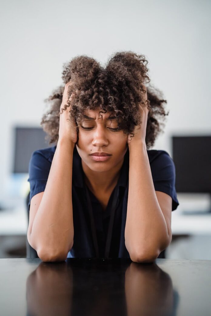 pexels-photo-12912159 tired woman with hands in hair