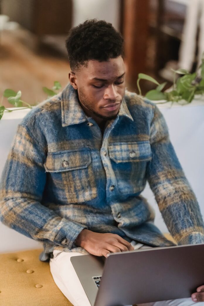 pexels-photo-6578443 focused black male freelancer working on laptop